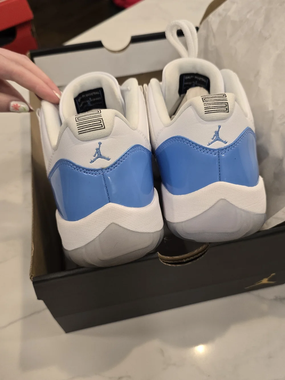 Air Jordan 11 Low Retro White and University Blue Sneakers